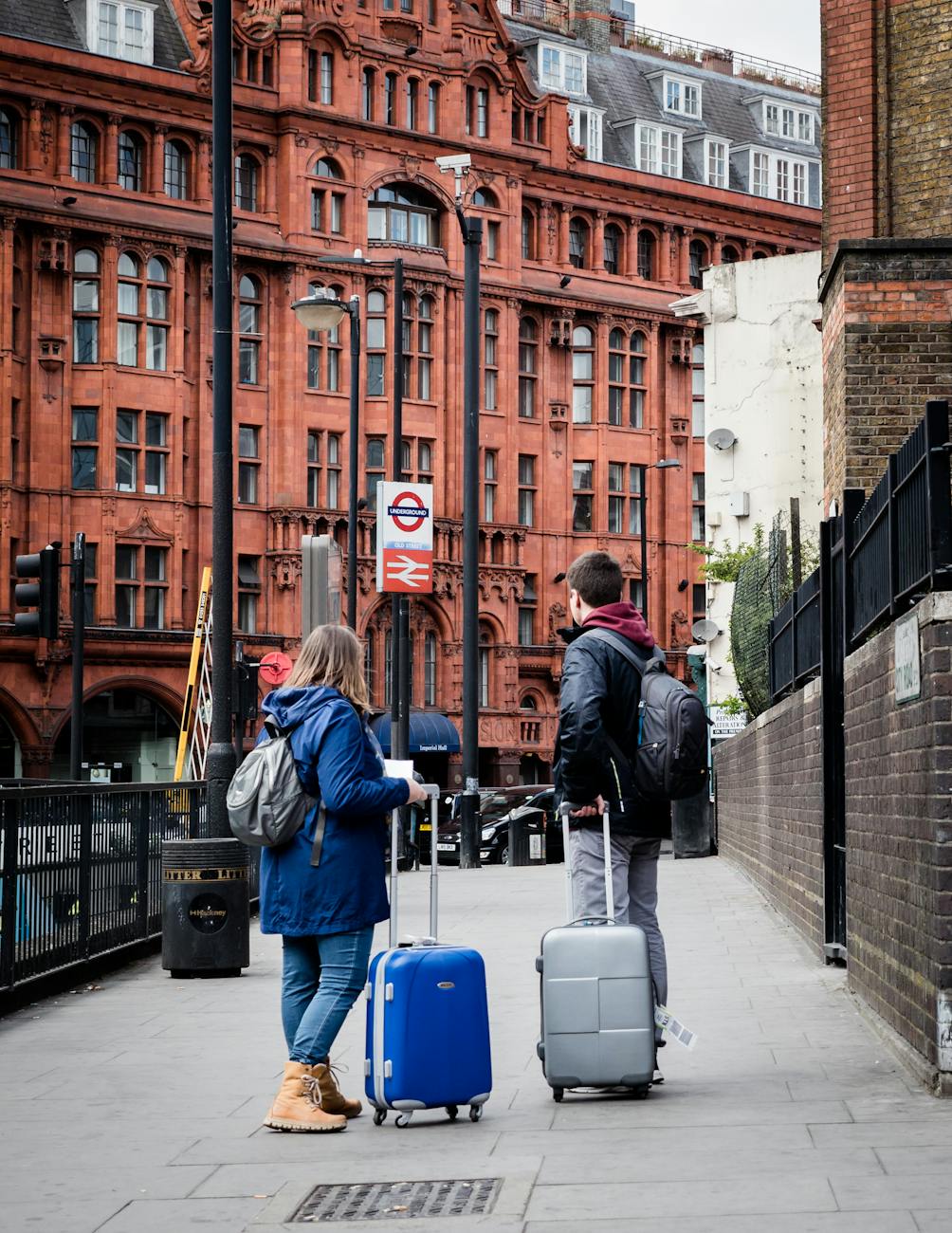 couple with suitcases on sidewalk